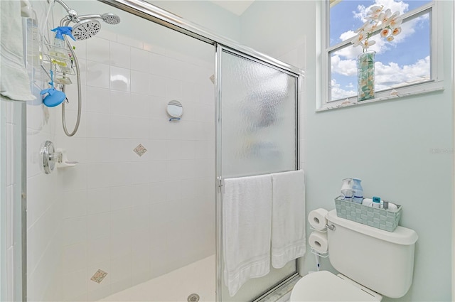 bathroom featuring walk in shower and toilet