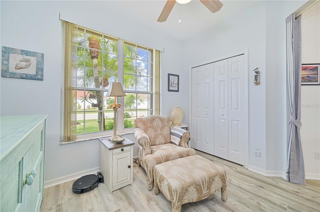 sitting room featuring ceiling fan and light wood-type flooring