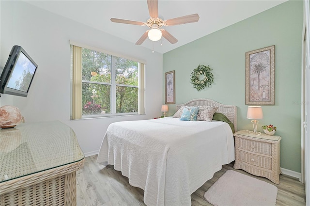 bedroom with ceiling fan and light hardwood / wood-style floors