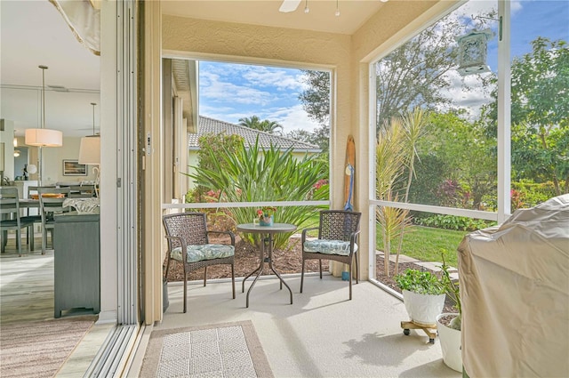 sunroom featuring ceiling fan