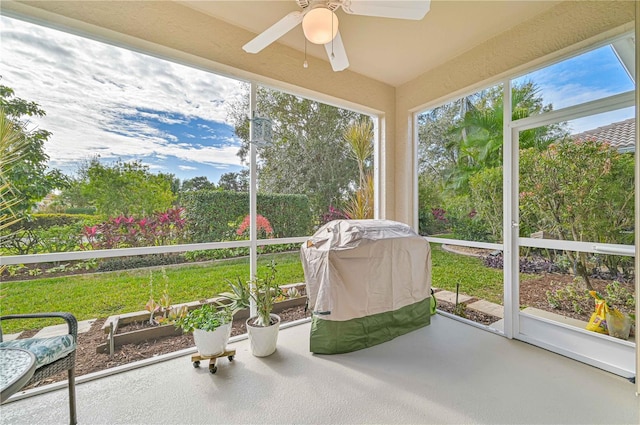 unfurnished sunroom with ceiling fan