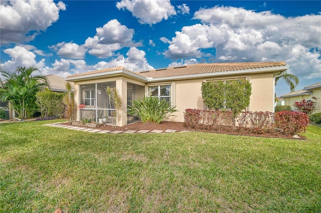 view of front of house with a front lawn and a sunroom