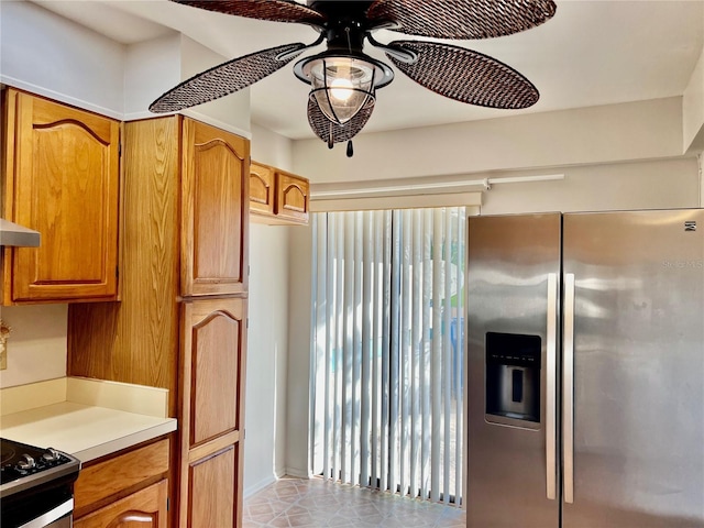 kitchen with black range oven, stainless steel fridge with ice dispenser, and ceiling fan