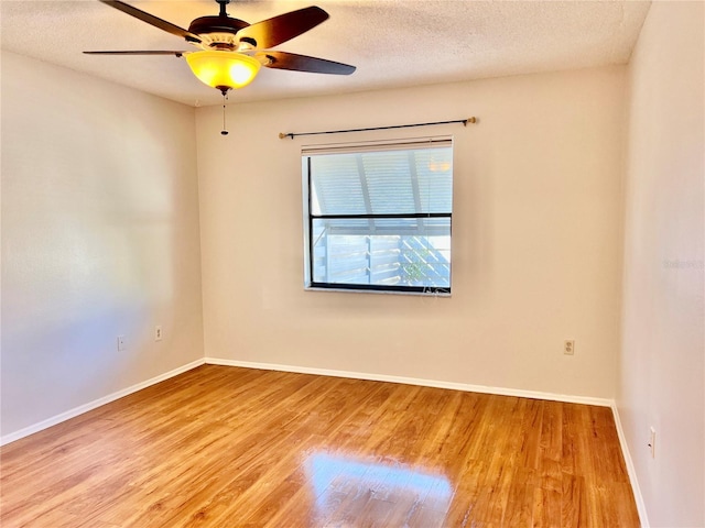 empty room featuring ceiling fan, light hardwood / wood-style floors, and a textured ceiling