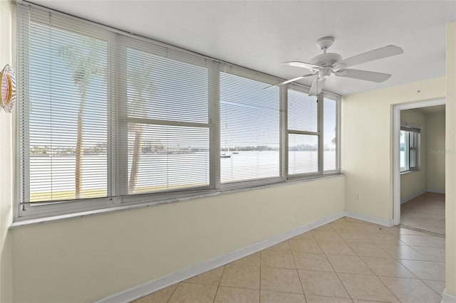 unfurnished sunroom with ceiling fan