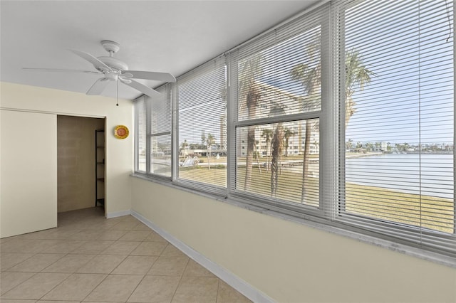 unfurnished sunroom featuring ceiling fan