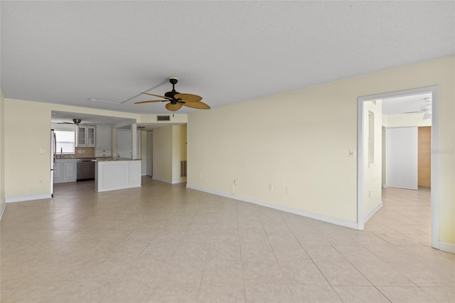 unfurnished living room featuring a textured ceiling and ceiling fan