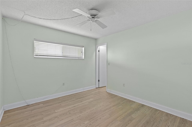 empty room featuring ceiling fan, a textured ceiling, and light wood-type flooring