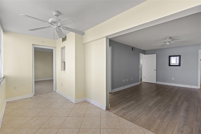 empty room featuring light tile patterned floors and ceiling fan