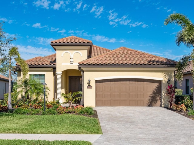 mediterranean / spanish home featuring a garage