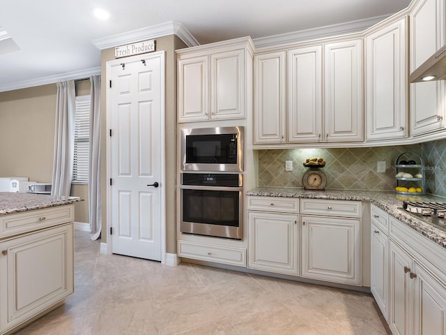 kitchen featuring tasteful backsplash, appliances with stainless steel finishes, and light stone countertops