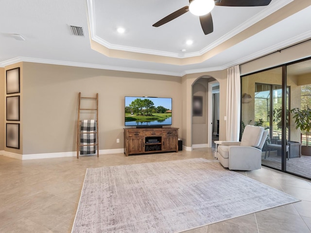 interior space featuring ornamental molding, a raised ceiling, and ceiling fan