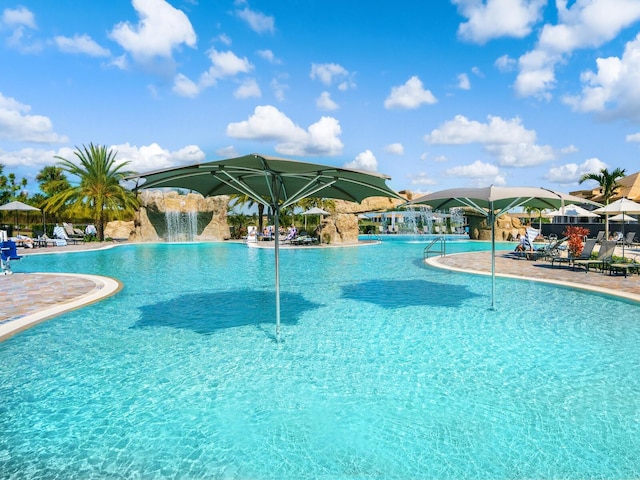 view of swimming pool with pool water feature