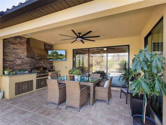 view of patio featuring ceiling fan, an outdoor kitchen, and grilling area