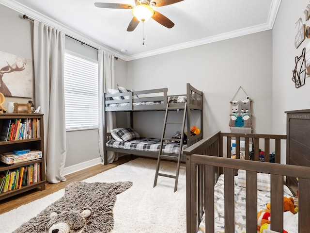 bedroom featuring crown molding, ceiling fan, and light hardwood / wood-style flooring