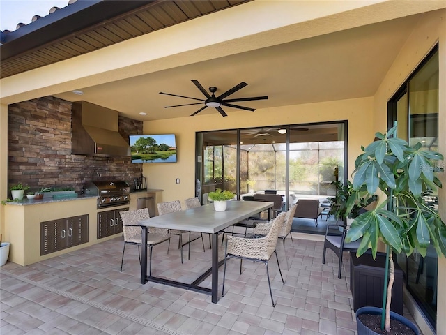 view of patio with area for grilling, a grill, and ceiling fan