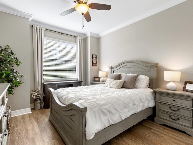 bedroom with crown molding, ceiling fan, and light wood-type flooring