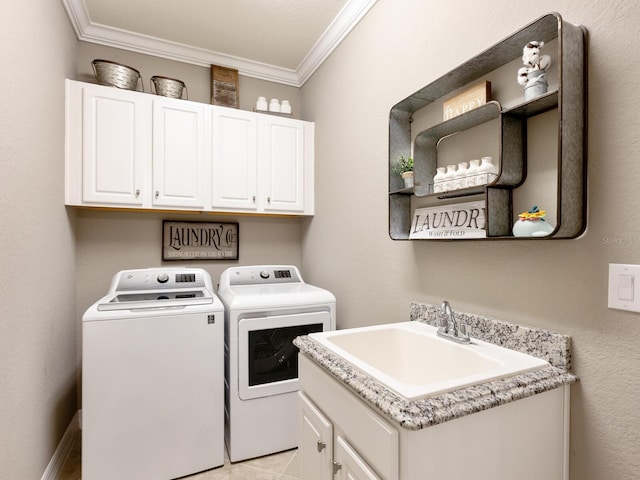 laundry area featuring separate washer and dryer, sink, crown molding, and cabinets