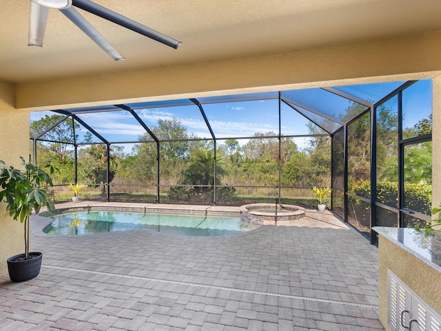 view of swimming pool featuring an in ground hot tub, a lanai, and a patio