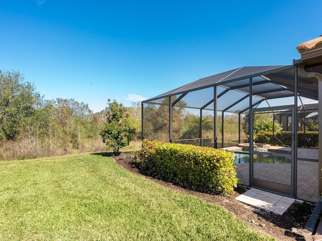 view of yard with glass enclosure