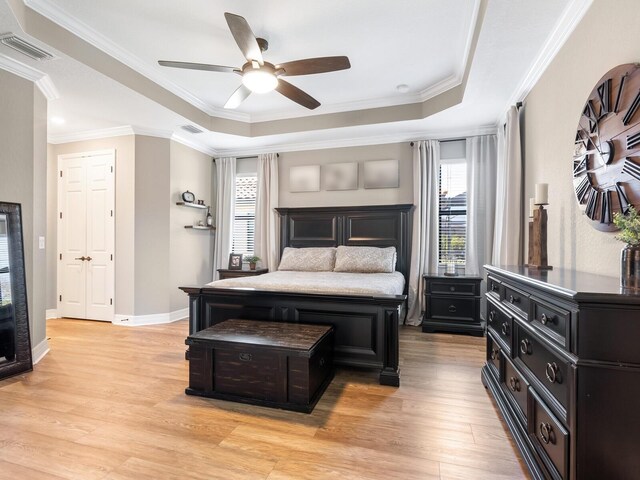 17459 Hickok Belt Loop, Bradenton, FL 34211 - bedroom with a raised ceiling, light wood finished floors, ornamental molding, ceiling fan, and baseboards