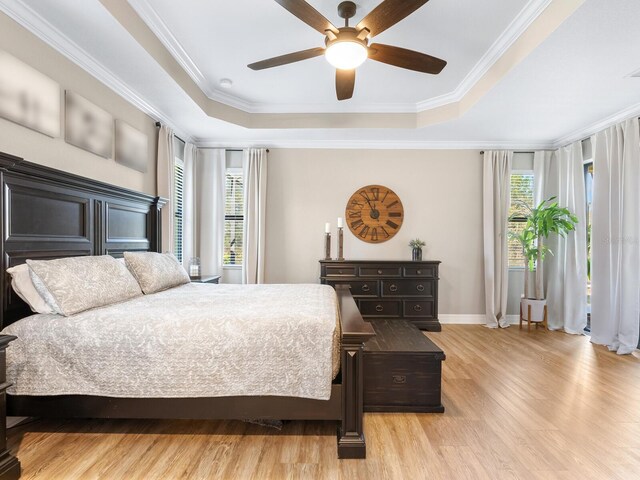 17459 Hickok Belt Loop, Bradenton, FL 34211 - bedroom featuring a raised ceiling, wood finished floors, baseboards, crown molding, and ceiling fan