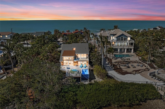 aerial view at dusk with a water view