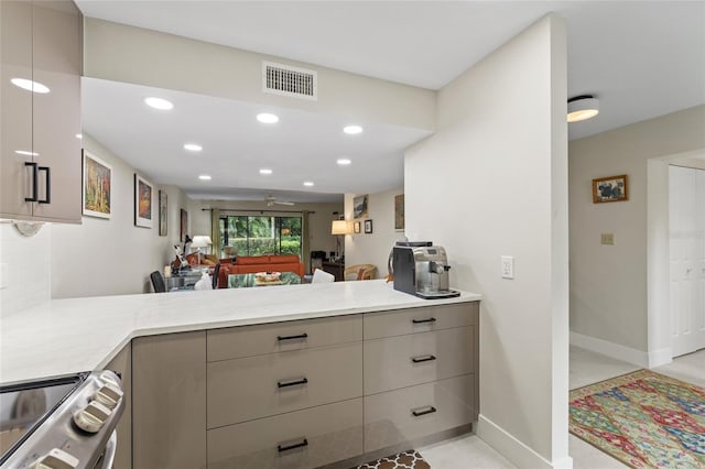 kitchen with tasteful backsplash, stainless steel electric range, kitchen peninsula, ceiling fan, and light stone countertops