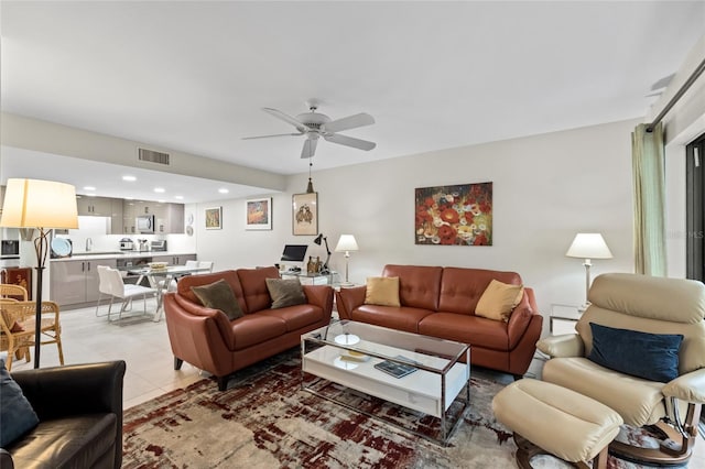 tiled living room featuring ceiling fan