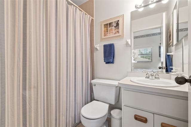 bathroom featuring vanity, toilet, and a shower with shower curtain