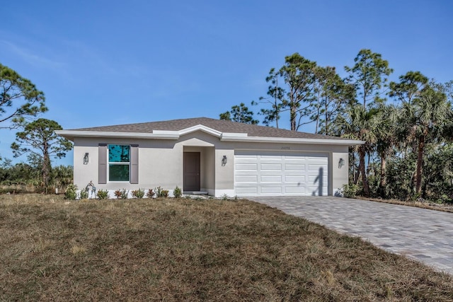 ranch-style home featuring a garage and a front yard