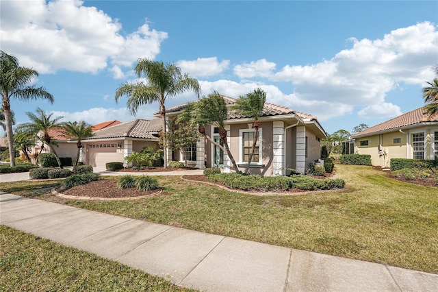 mediterranean / spanish home with a garage and a front yard