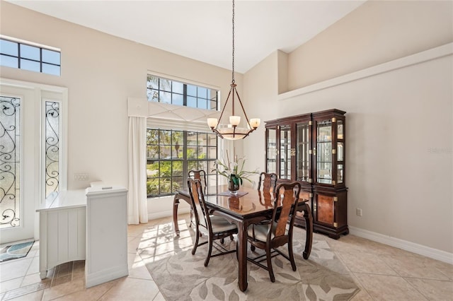 tiled dining area with radiator heating unit, a chandelier, and a high ceiling