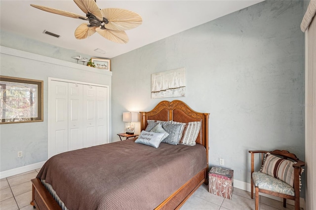 bedroom featuring ceiling fan, a closet, and light tile patterned floors