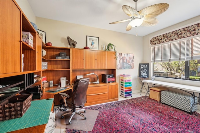 office space with ceiling fan and built in desk