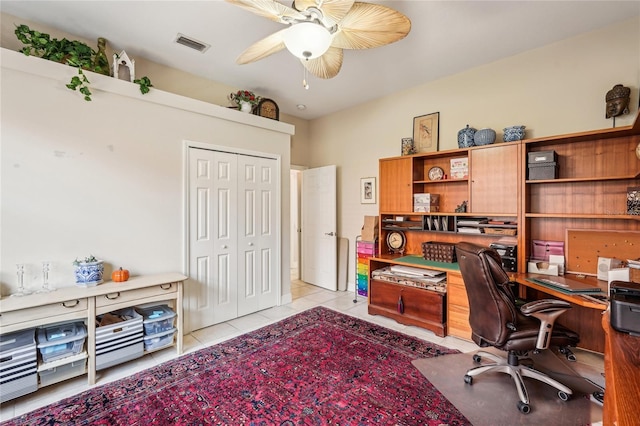 tiled office featuring ceiling fan