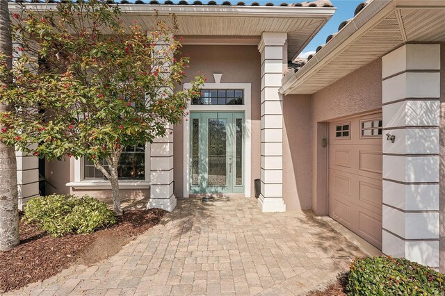 doorway to property with a garage