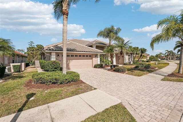 mediterranean / spanish-style home with a garage