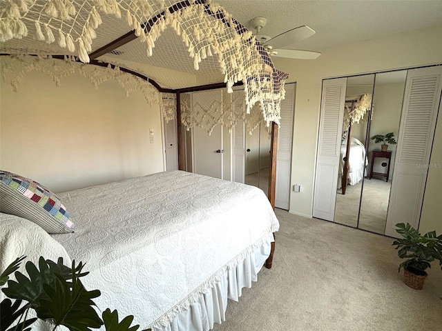 unfurnished bedroom featuring two closets, carpet floors, and ceiling fan