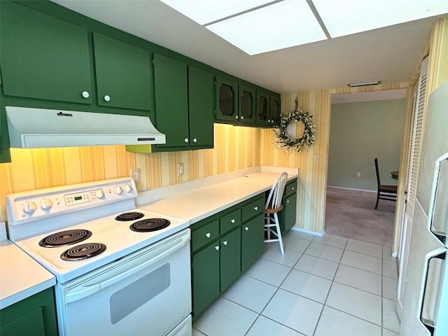 kitchen with light tile patterned floors, white electric stove, range hood, and green cabinets