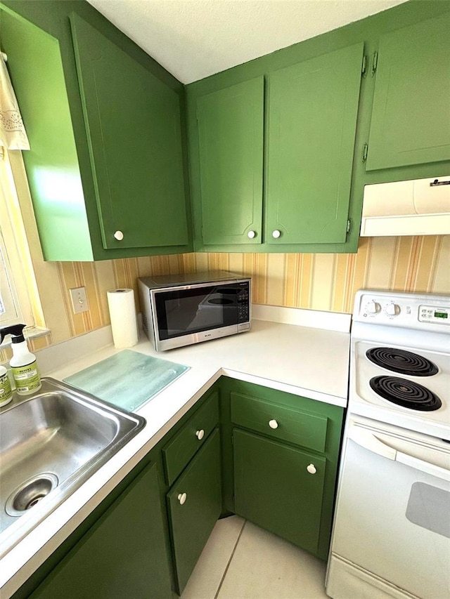 kitchen with white electric range, range hood, sink, green cabinets, and light tile patterned floors