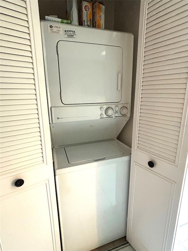 laundry room with stacked washer and dryer