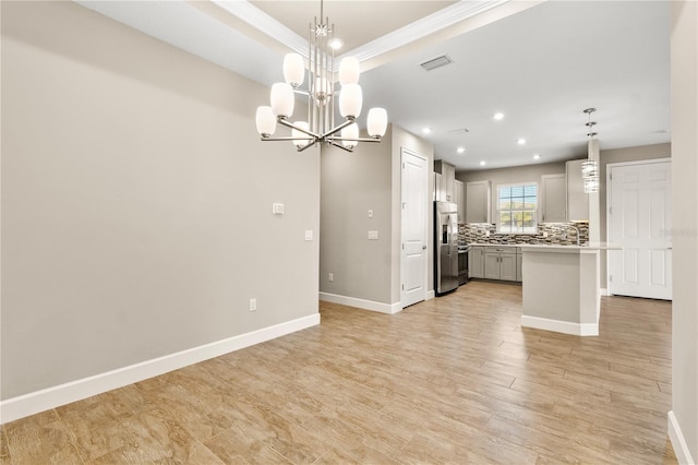 kitchen with pendant lighting, stainless steel fridge with ice dispenser, a kitchen island, and backsplash