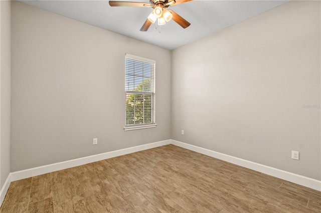 spare room featuring hardwood / wood-style floors and ceiling fan