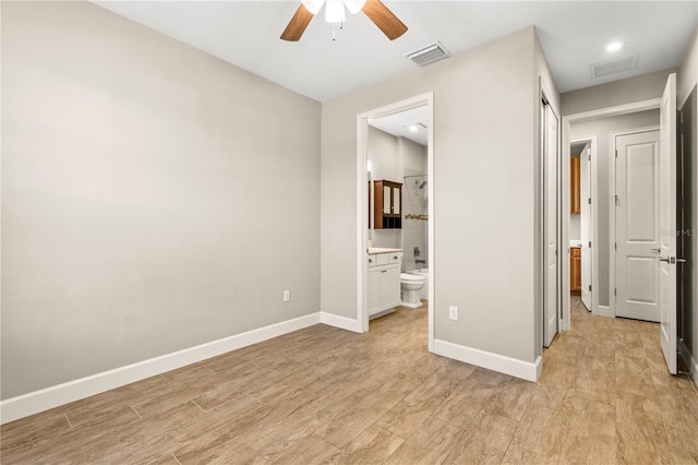 unfurnished bedroom with connected bathroom, light hardwood / wood-style flooring, and ceiling fan