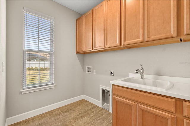 laundry area with sink, cabinets, washer hookup, hookup for an electric dryer, and light wood-type flooring