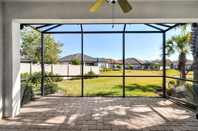 unfurnished sunroom with plenty of natural light and ceiling fan