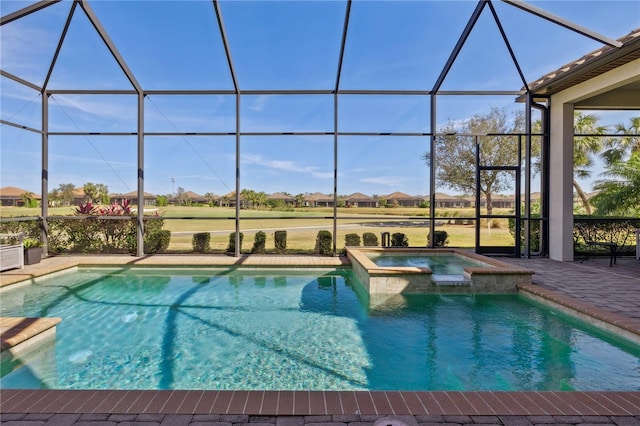 view of swimming pool with a patio area, a pool with connected hot tub, and glass enclosure