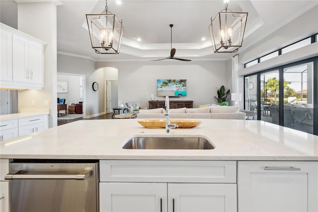 kitchen with open floor plan, arched walkways, dishwasher, and a notable chandelier