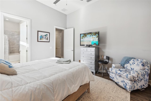 bedroom featuring visible vents, a ceiling fan, connected bathroom, and wood finished floors